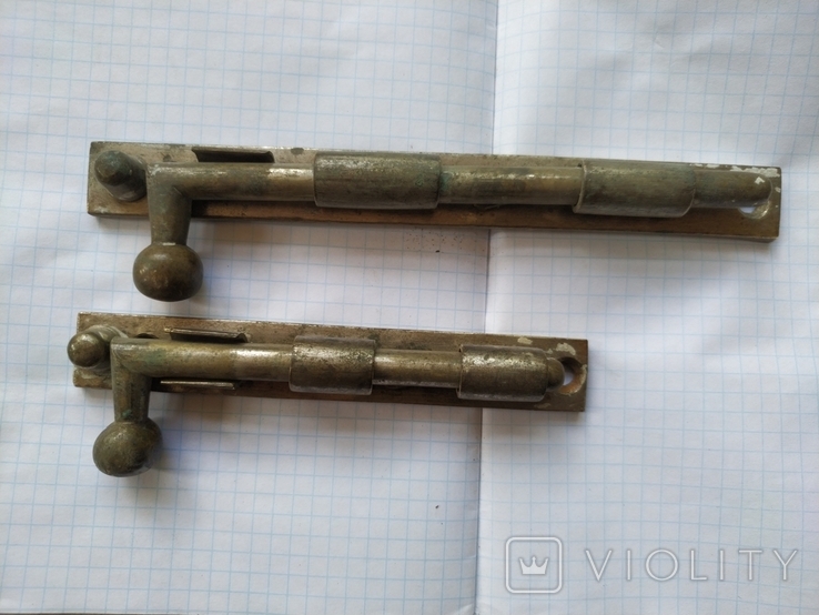 A pair of bronze spindles.