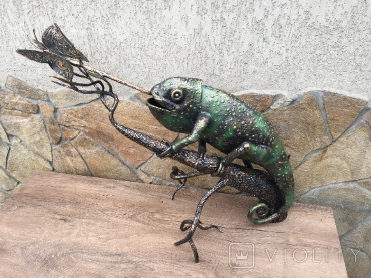 A chameleon on a branch hunting a butterfly, photo number 3