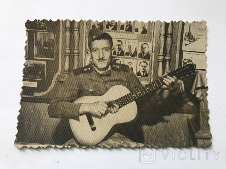 Photo of a soldier with a guitar