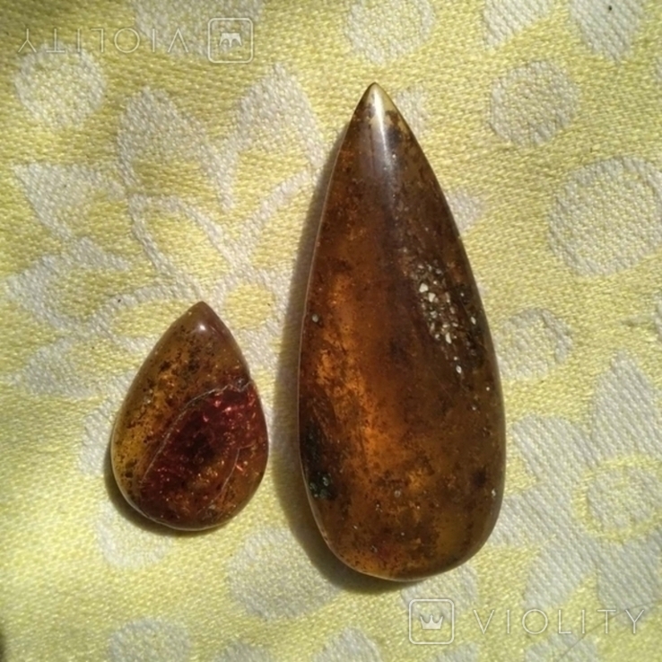 Two amber pendants.