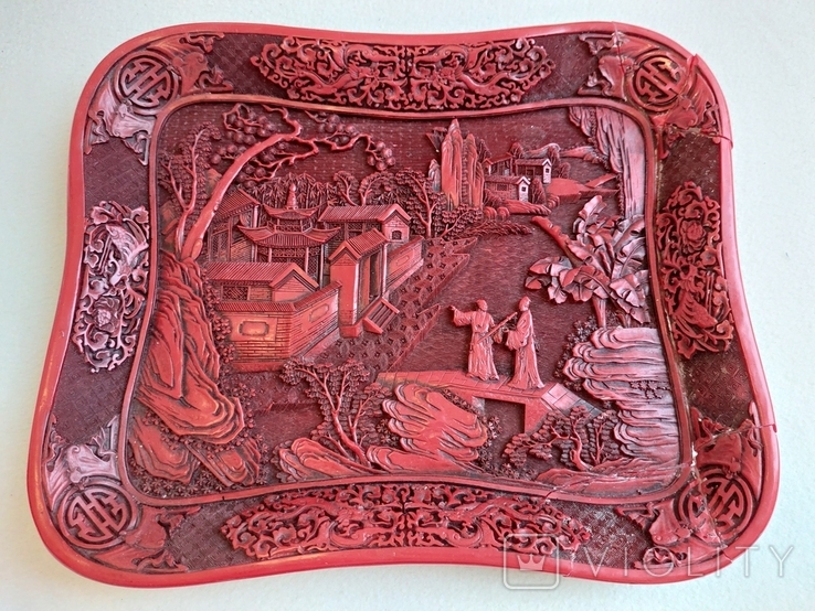 An antique Chinese tray with a carved story about a martial arts school