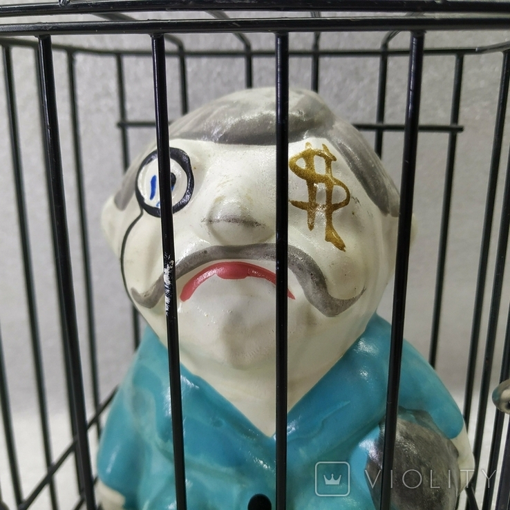 Piggy bank in a cage under lock and key., photo number 3
