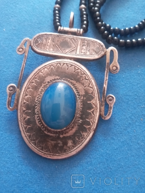 The silver pendant is a large interesting stone.