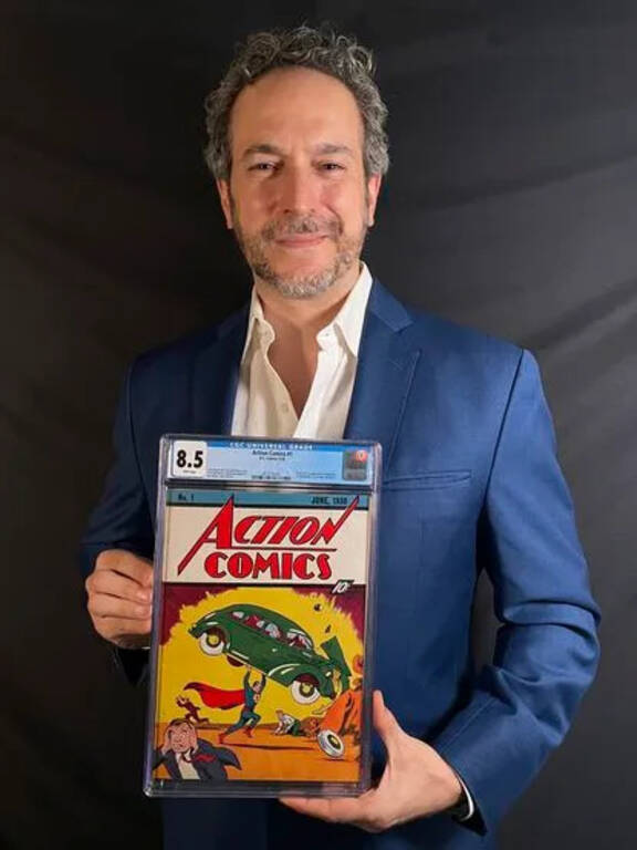 Auction broker Vincent Zurzolo holding an Action Comics #1