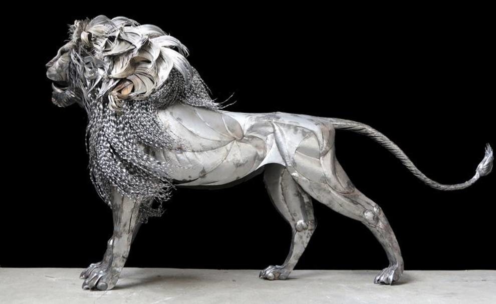 Steel lion with relief muscles and a mane growing in the wind