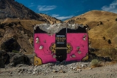 Prada, Chanel and Gucci bags decorating the concrete walls of the Oregon desert