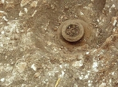 Archaeologists have helped the searcher to extract from the earth a ceramic vessel with ancient coins