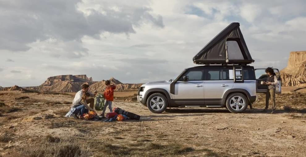 The iconic SUV Land Rover Defender equipped with a tent