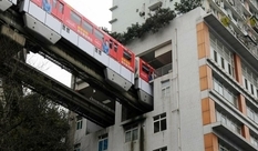 Next stop - apartment: in China, a train passes through an apartment building